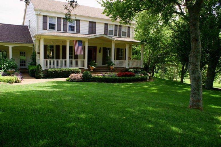 Green lawn by all-American house